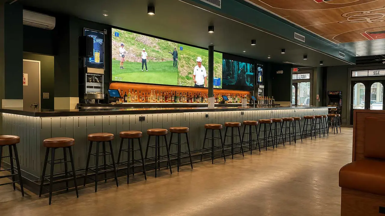 Atlee's Rally sports bar with long bar, stools and large video wall, San Antonio