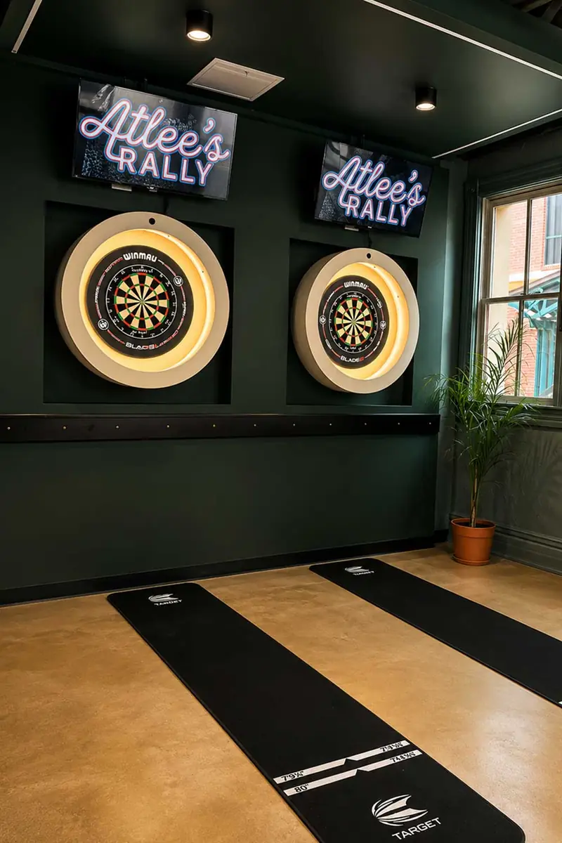 Dartboard lanes with neon Atlee's Rally signs
